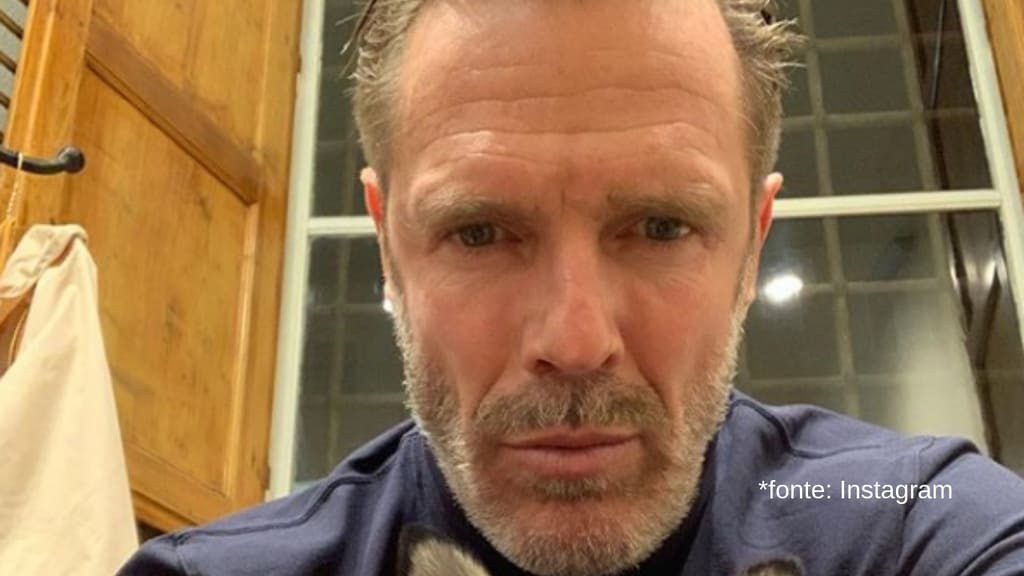 primo piano di mario cipollini con un cagnolino tra le braccia