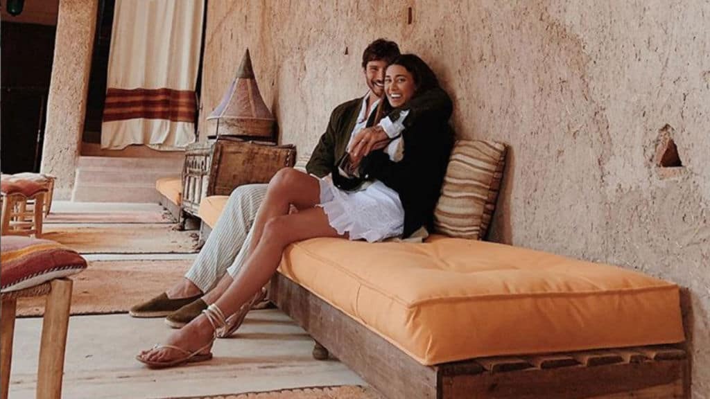 belen e stefano seduti e sorridenti