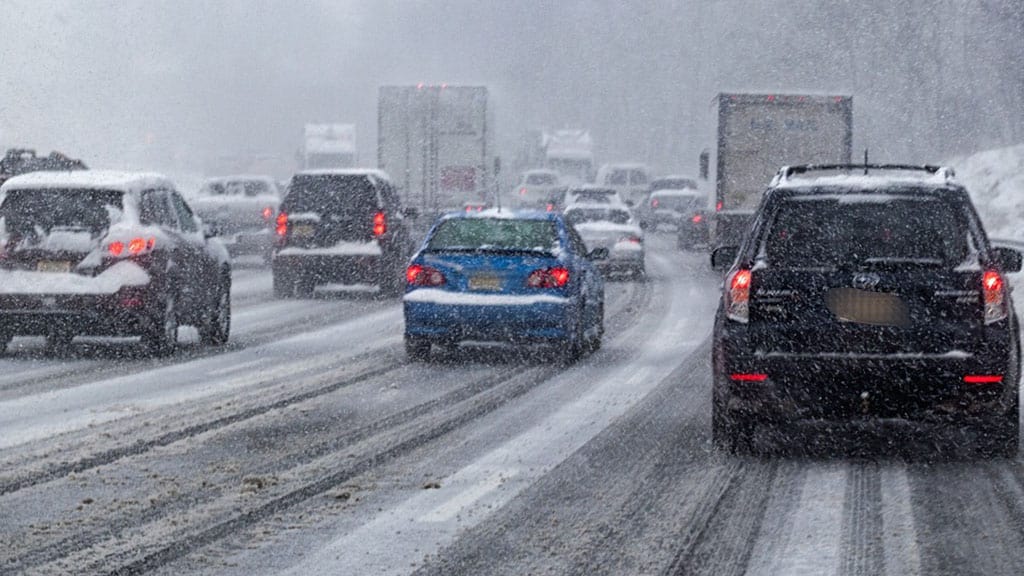 macchine su strada sotto la neve