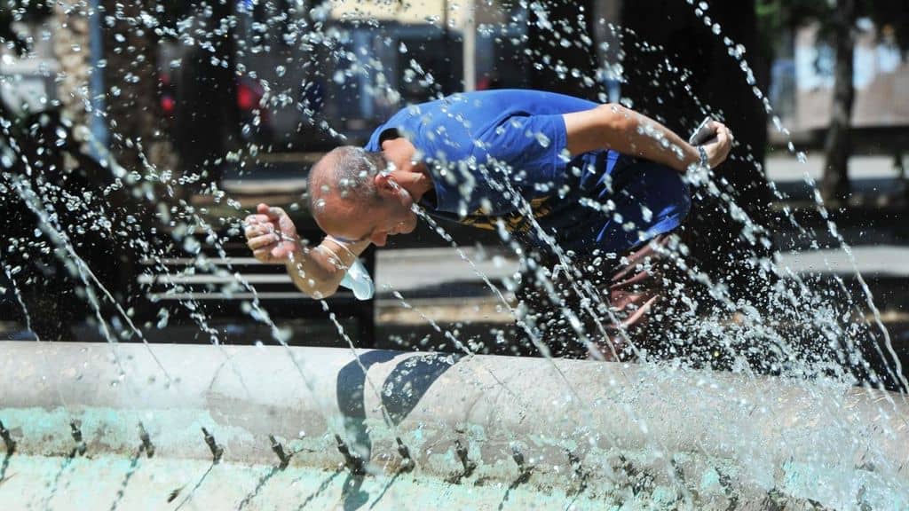 uomo si bagna nella fontana